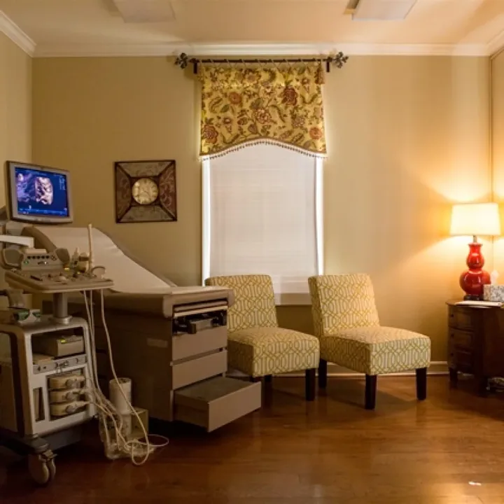A quiet exam room at Life Choices, with two chairs and a lamp